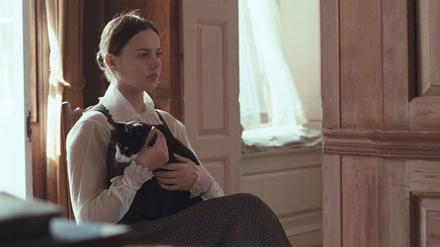 Bright Star - Fanny Abbie Cornish sitting with tuxedo cat Topper on her lap