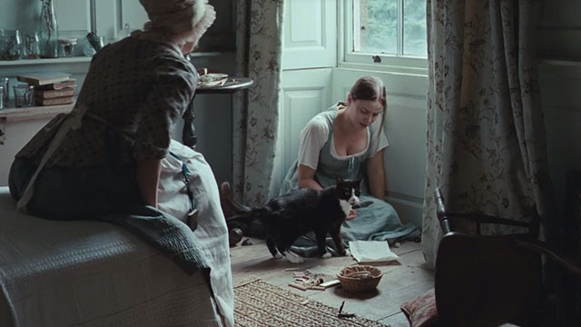 Bright Star - Fanny Abbie Cornish crying in corner of room with tuxedo cat Topper