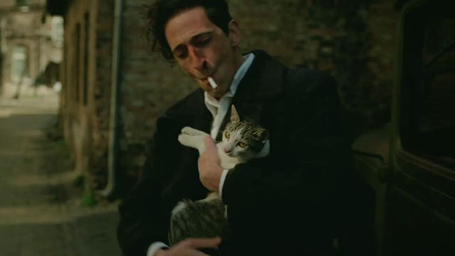 The Brutalist - László holding tabby and white cat
