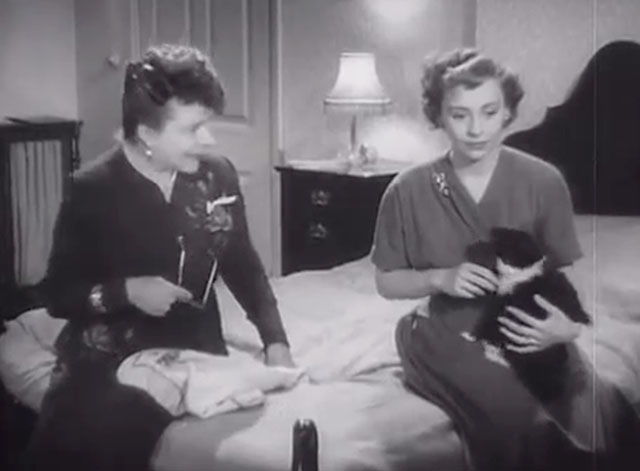 Burnt Evidence - Diana Jane Hylton on bed holding tuxedo cat with Mrs. Raymond Irene Handl