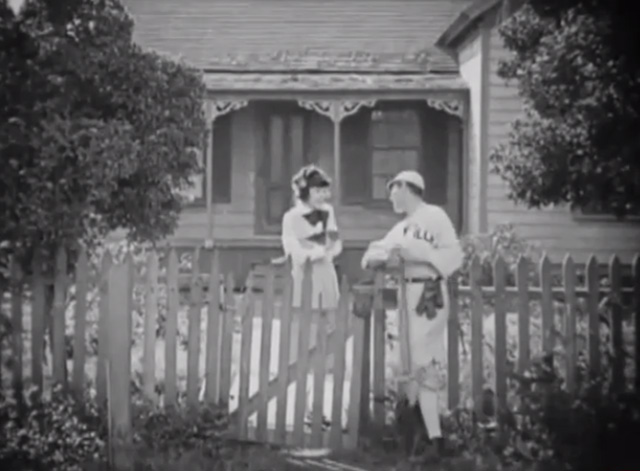 The Busher - Mazie Colleen Moore holding tabby kitten at fence with Ben Charles Ray