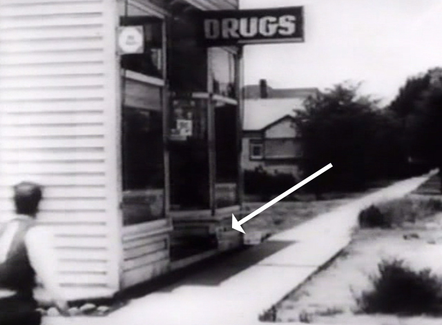 The Cameraman - black cat on drugstore step as Buster Keaton approaches
