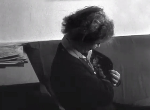 Candid Camera with Lee Miller - sitting on couch with tabby kitten tucked inside jacket