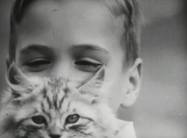 Can You Imagine? - boy Dickie McCollin holding longhair tabby kitten in front of his face