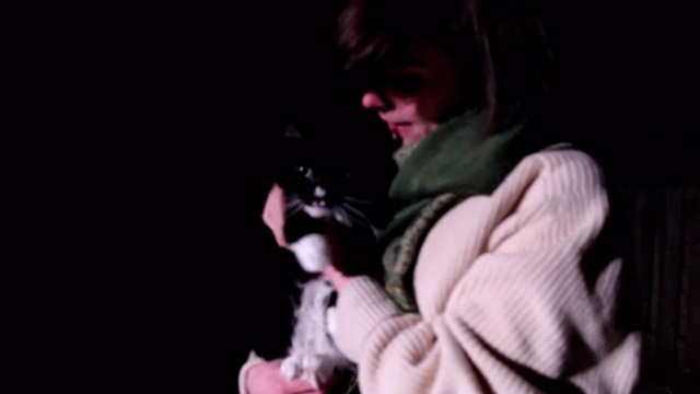 Capture Kill Release - Jennifer Fraser holding tuxedo Norwegian Forest Cat Mittens Snorri at night