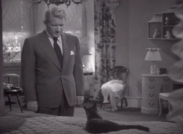 Cass Timberlane - Cass Timberlane Spencer Tracy looking at tabby cat Cleo on bed