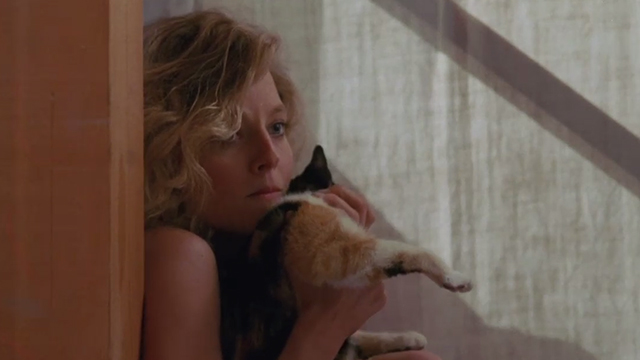 Catchfire - Anne Jodie Foster cowering in corner with tortoiseshell cat Frida