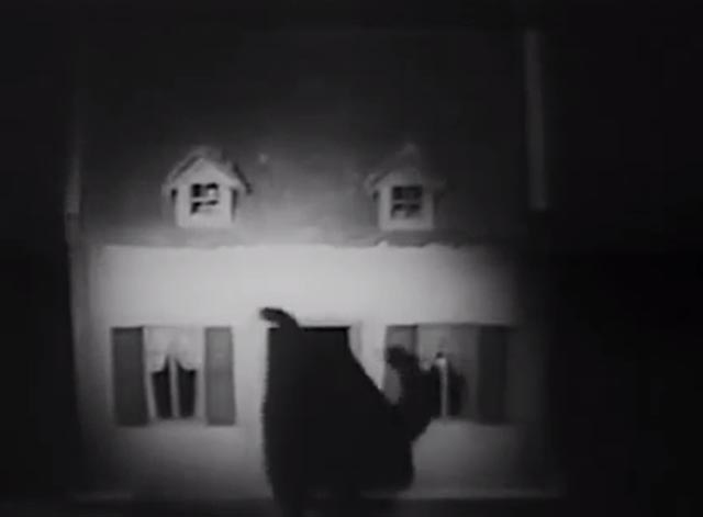 The Cat Creeps - black cat walking into dollhouse