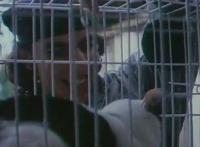 U.S. Catman Lethal Track - thug looking at tuxedo cat in cage