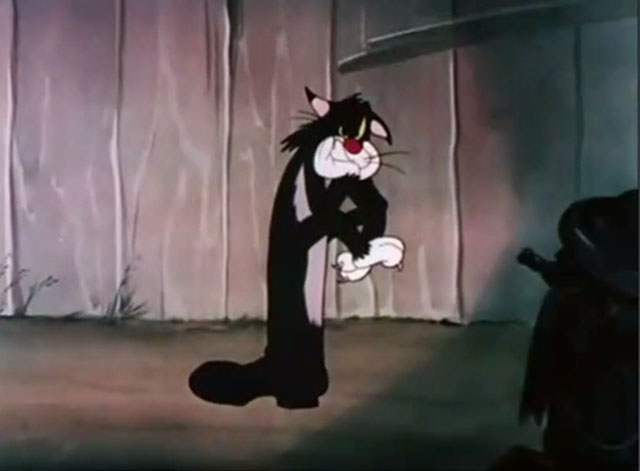 The Cat That Hated People - sulking cartoon black cat standing on boot inside tail