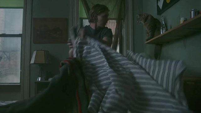 Caught Stealing - Hank Austin Butler looking at longhair brown tabby cat Bud Tonic sitting on shelf