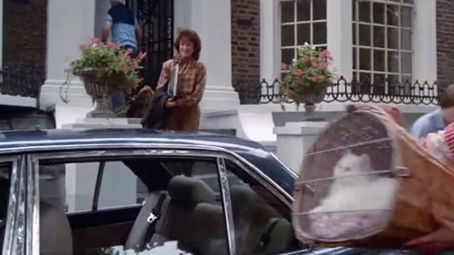 The Chain - Rosemary Charlotte Long carrying wicker basket holding longhair white cat Lady Diana to car