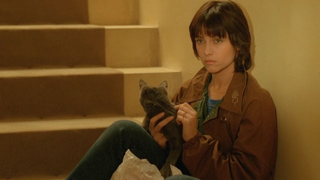 Le Choc - The Shock - Mathilde Catherine Leprince sitting on stair holding gray cat Soudan