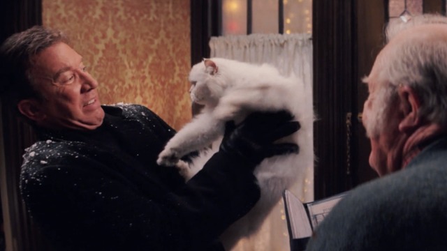 Christmas with the Kranks - Luther holding white Persian cat Muffles at arms length