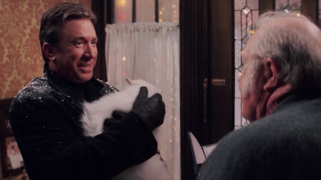Christmas with the Kranks - Luther holding white Persian cat Muffles in arms