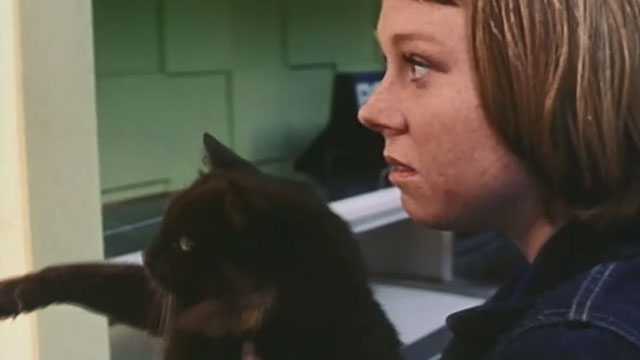 City Loop - fast food worker Katie Hayley McElhinney holding black cat Terry in restaurant