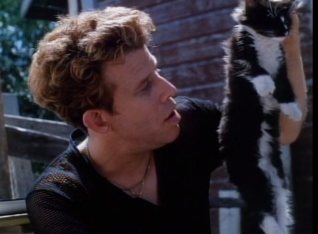 Cold Feet - Kenny Tom Waits holding up tuxedo cat by scruff