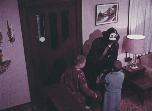 Color Me Red - fireman handing black cat to little boy Steve