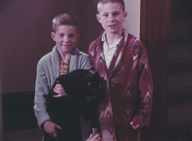 Color Me Red - little boy Steve holding black cat with his big brother