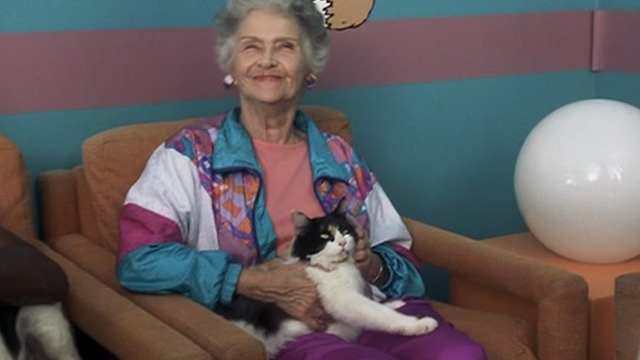 Corky Romano - Phyllis Jeanette Miller holding calico cat on lap