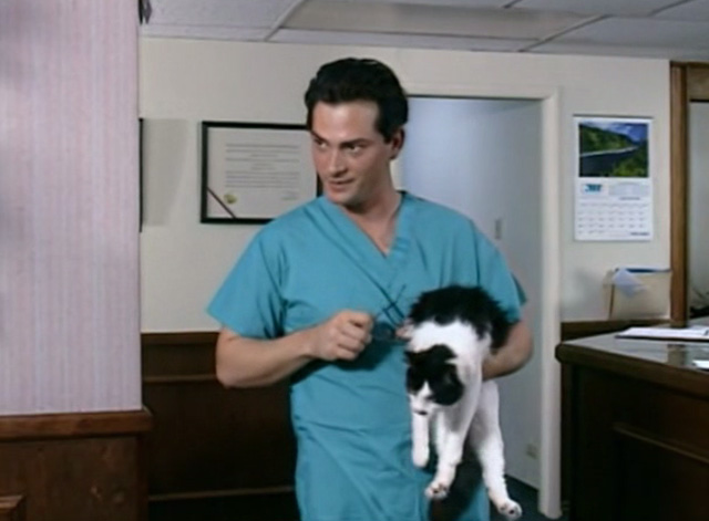 The Corpse Grinders 2 - tuxedo cat Kitty held by Dr. Glass Paul MacDonald