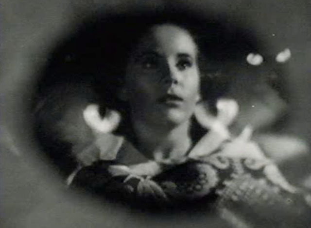 The Creeper - terrified Nora Janis Wilson surrounded by images of black cat eyes