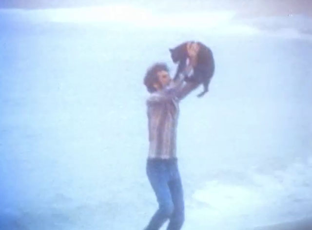 The Cremators - hippie Mason Caulfield running on beach with black cat