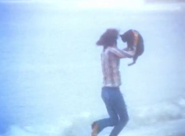 The Cremators - hippie Mason Caulfield running on beach with black cat