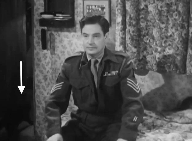 The Cure for Love - Jack Robert Donat sitting on bed with black cat exiting room