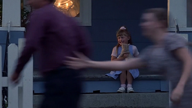 Dante's Peak - crying girl holding orange tabby kitten when volcano erupts