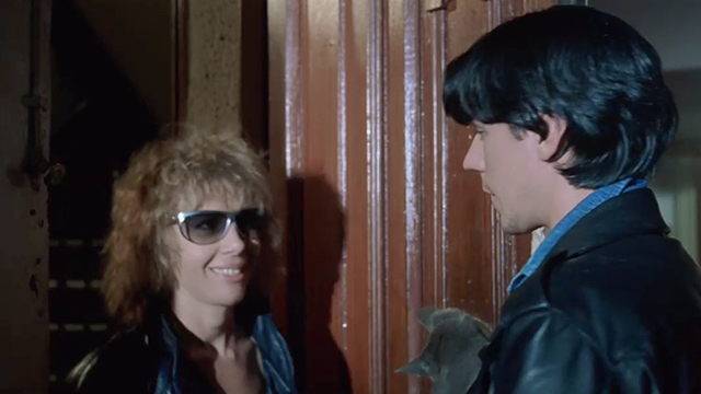 Datk Habits - Jorge Willmore holding blue grey short hair kitten as Yolanda Cristina S. Pascual enters