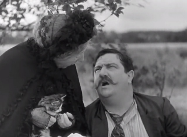 A Day in the Country - grandmother Gabrielle Fontan sitting and holding tabby kitten at picnic
