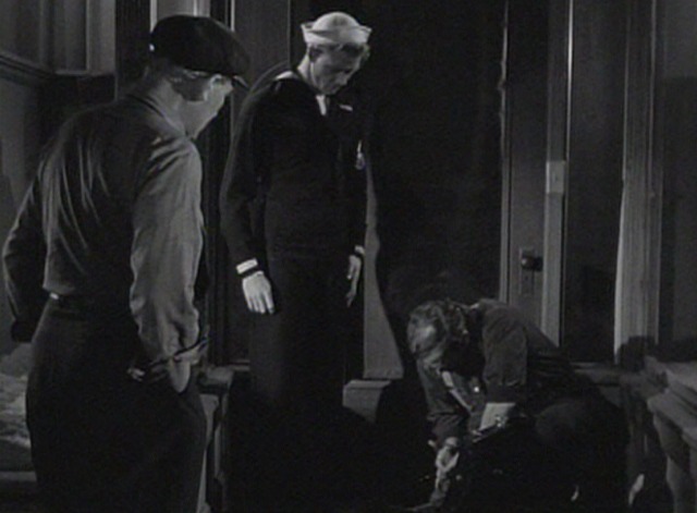 Deadline at Dawn - man looking down at dead cat in tool box