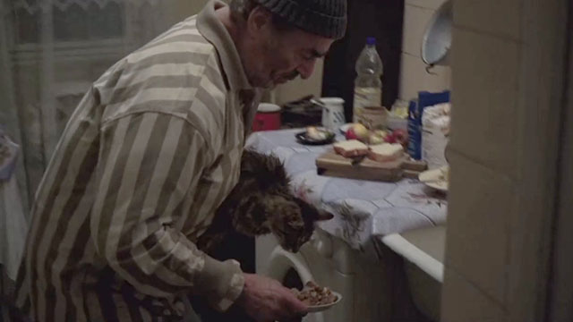 The Death of Mr. Lazarescu - Ion Fiscuteanu feeding brown tabby cat Mirandolina