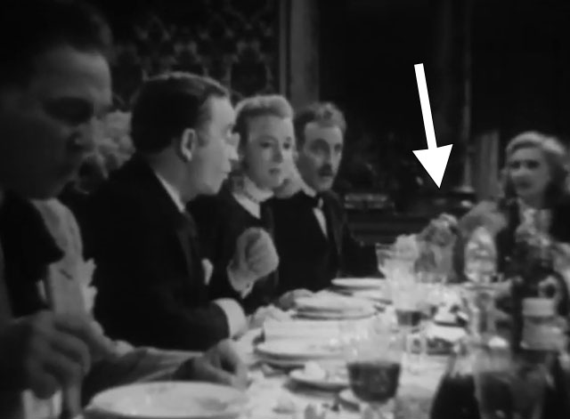 Death Walks in the Rain - La muerte camina en la lluvia - longhair tabby cat on dining table with Valeria Duval Margarita Corona