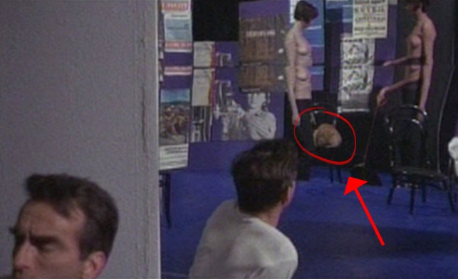 The Defector - orange cat sitting on chair between two topless women