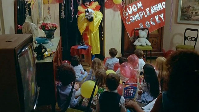 Delitto sull'autostrada - Crime on the Highway - Nico Tomas Milian dressed as clown holding tuxedo cat Filiberto at birthday party