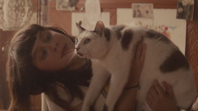 Diary of a Teenage Girl - grey and white cat Domino Willie held by Minnie Bel Powley