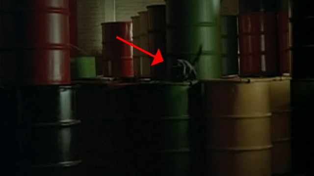 Dick Tracy - black cat on metal barrels