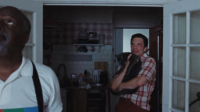 A Different Man - blue cat held by Edward Sebastian Stan lap with Ollie Billy Griffith