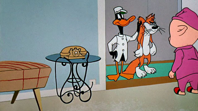 Dime to Retire - Daffy Duck holding ginger and white cartoon cat by scruff at door with Porky Pig