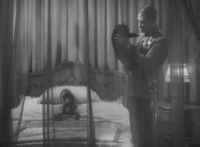 Dishonored - long-haired black cat Blackie being held by Colonel Kranau Victor McLaglen