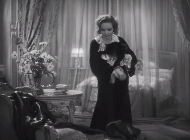 Dishonored - long-haired black cat Blackie being carried by Marie Marlene Dietrich