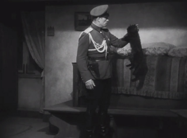 Dishonored - long-haired black cat Blackie being held by scruff by Colonel Kranau Victor McLaglen