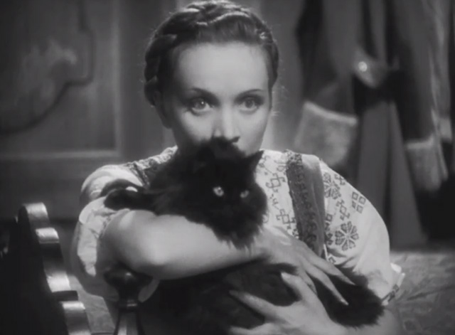 Dishonored - long-haired black cat Blackie being clutched by Marie Marlene Dietrich looking intense