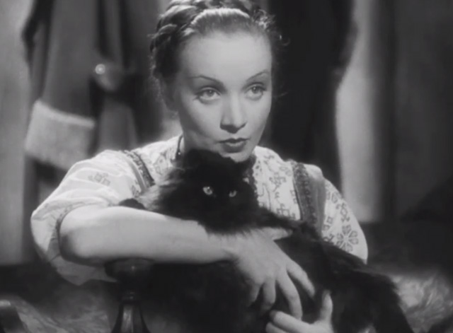 Dishonored - long-haired black cat Blackie being clutched by Marie Marlene Dietrich