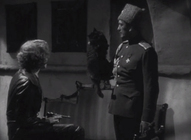 Dishonored - long-haired black cat Blackie being held by scruff by Colonel Kranau Victor McLaglen with Marie Marlene Dietrich