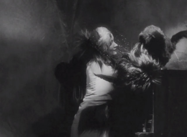 Dishonored - long-haired black cat Blackie being picked up from piano by Marie Marlene Dietrich