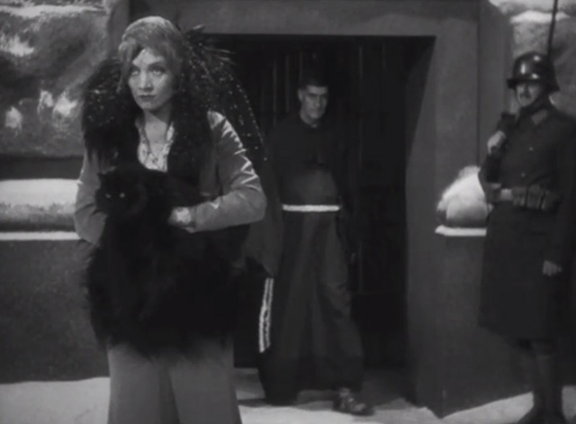 Dishonored - long-haired black cat Blackie being carried by Marie Marlene Dietrich to execution yard