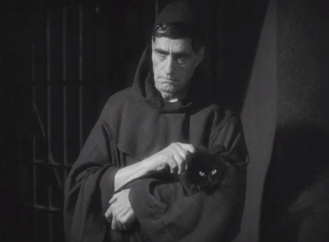 Dishonored - long-haired black cat Blackie being held by priest